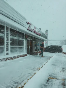 store signage covered in snow